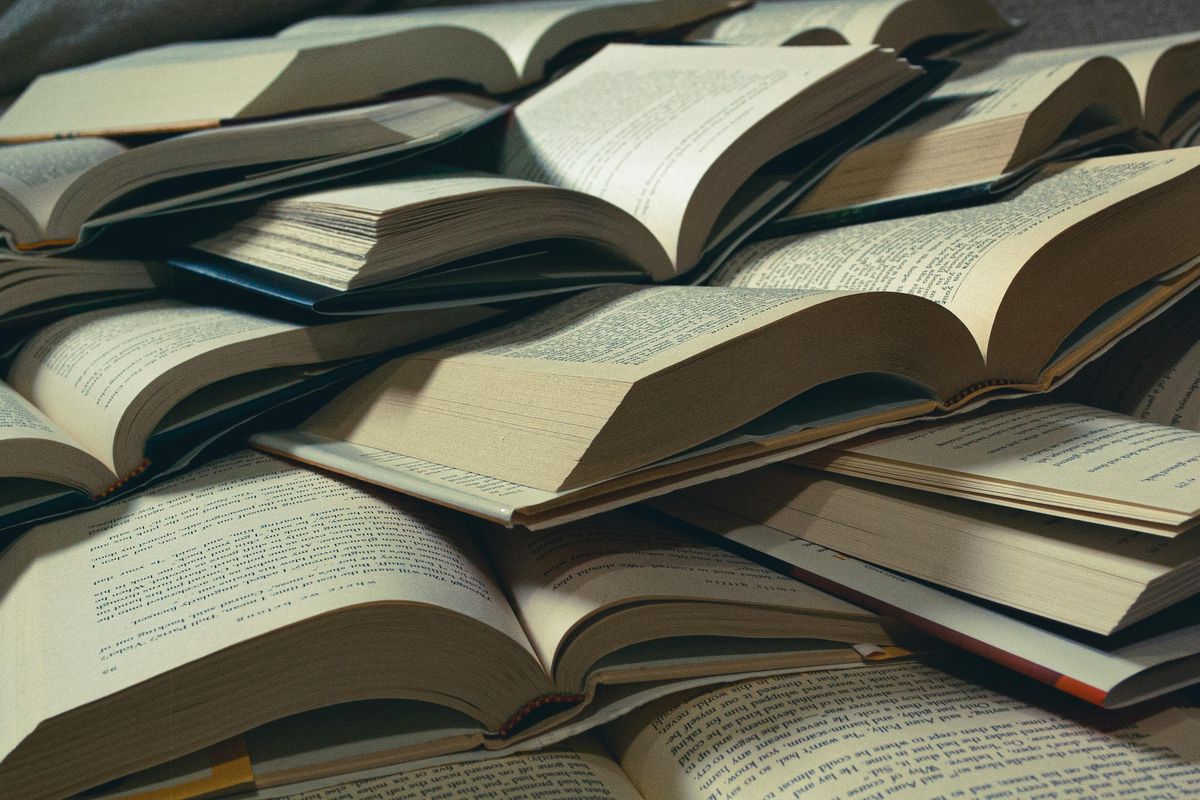 A close-up view of a pile of open books cover