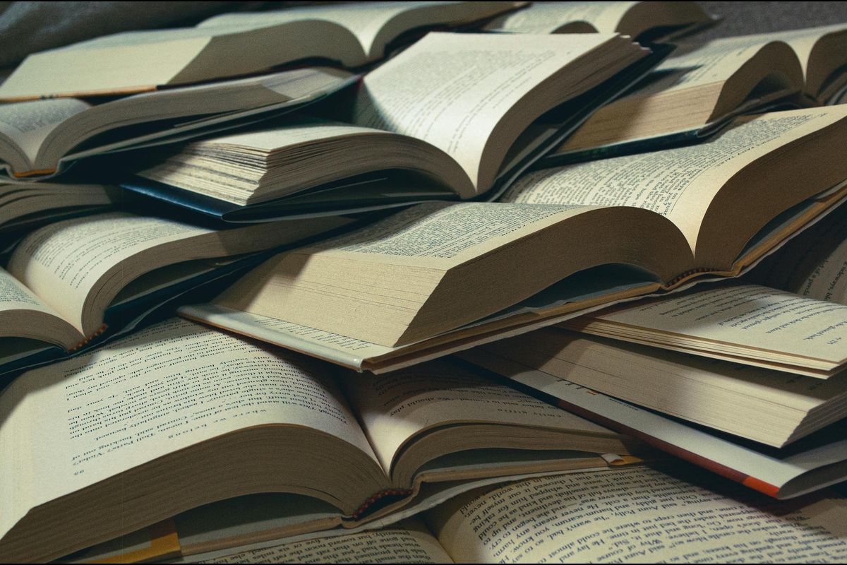 A close-up view of a pile of open books